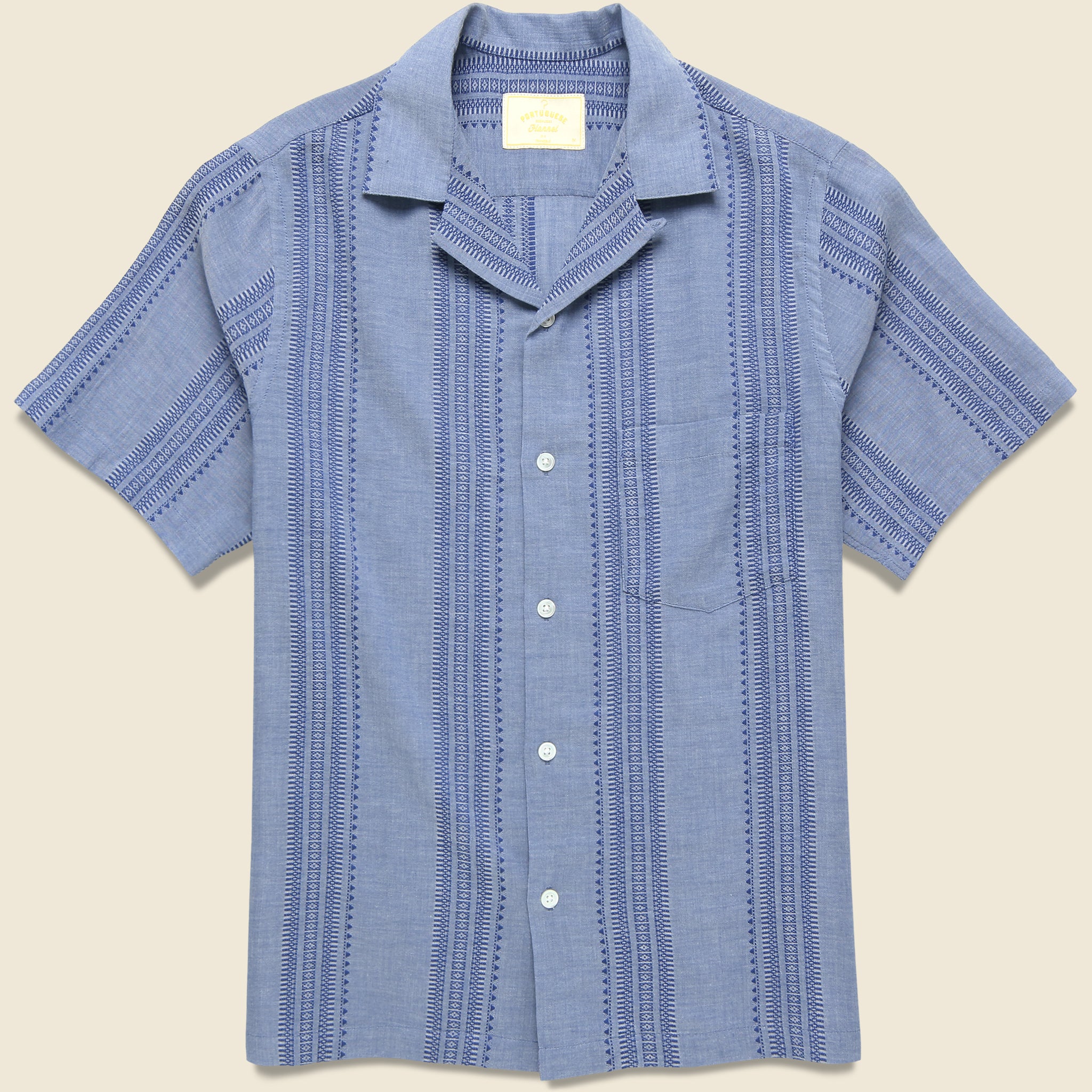Portuguese Flannel Pacific Camp Shirt in indigo blue with a geometric stripe pattern, camp collar, chest pocket, and relaxed short-sleeve fit.